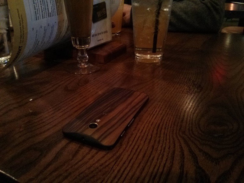 Man sieht ein Handy, dass der Vater verloren hat, weil die Handyhülle nicht vom Tisch zu unterscheiden ist