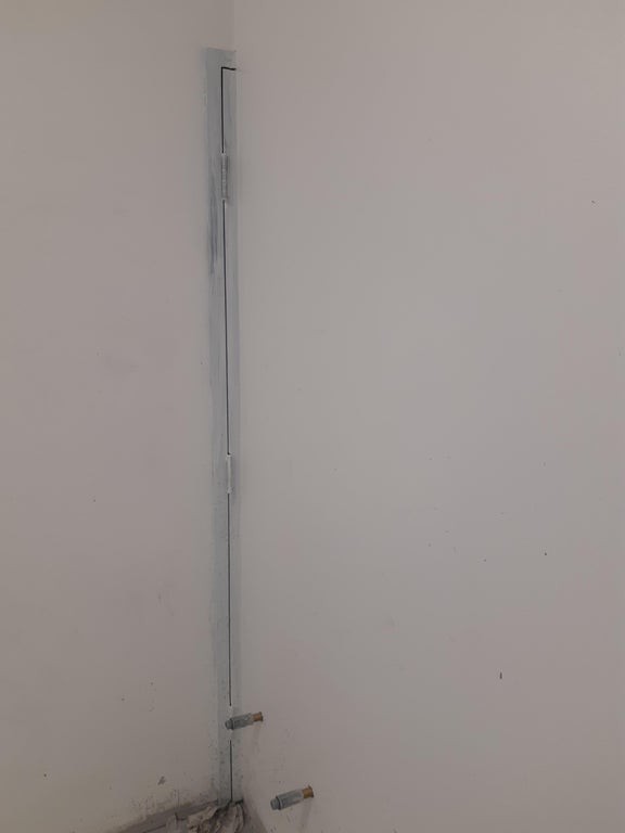 Hinter der Wand guckt noch ein kleines Stück von der zugemauerten Tür hervor.